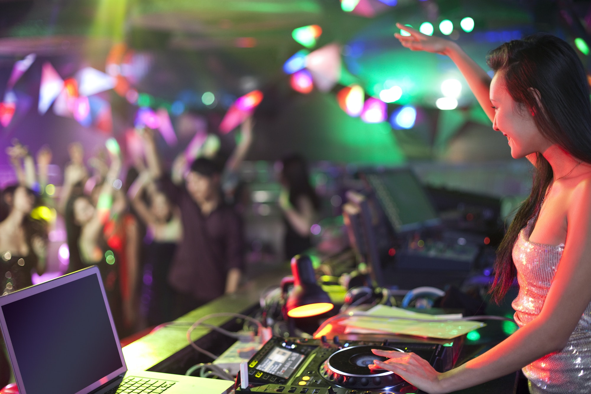 DJ doing record Scratching in nightclub